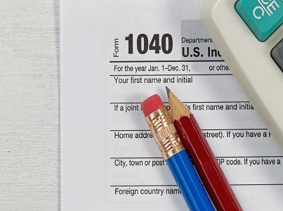 Form 1040 With Two Pencils and a Calculator